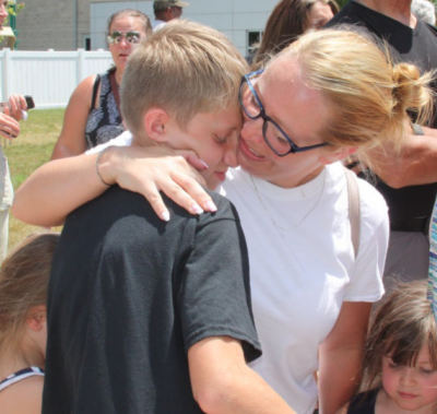 Becky Gifford and her son Chase Colon are reunited at the YMCA after schools were evacuated following a shooting threat. Photo by: Lydia Goerner