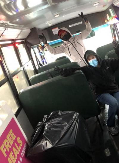 Bus drivers pose on the bus while sorting donations into garbage bags. Photo courtesy: Wareham Public Schools Transportation Department