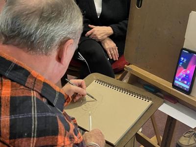 Herby Thompson works on his portrait of Anne Doherty at the Wesley United Methodist Church art show on Saturday, Oct. 22. Photo by Wes Cipolla