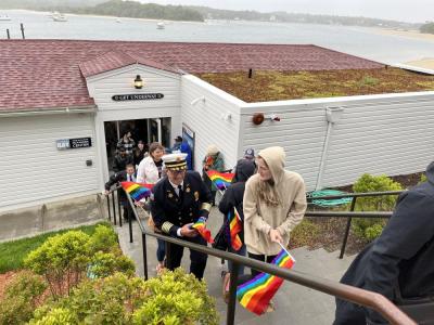 The ceremony attendees ran outside into the rain for the flag raising before returning inside for a reception and silent auction.