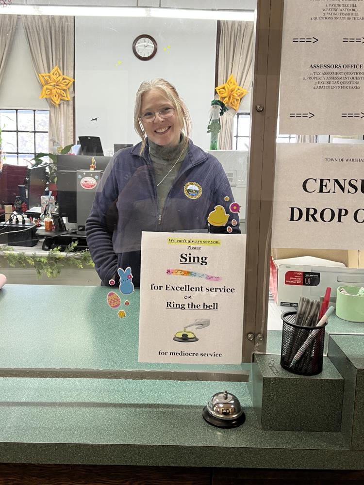  Assistant Town Clerk Shayne Martin and the sign she added pizzaz to with stickers and icons. Photos by Brandy Muz