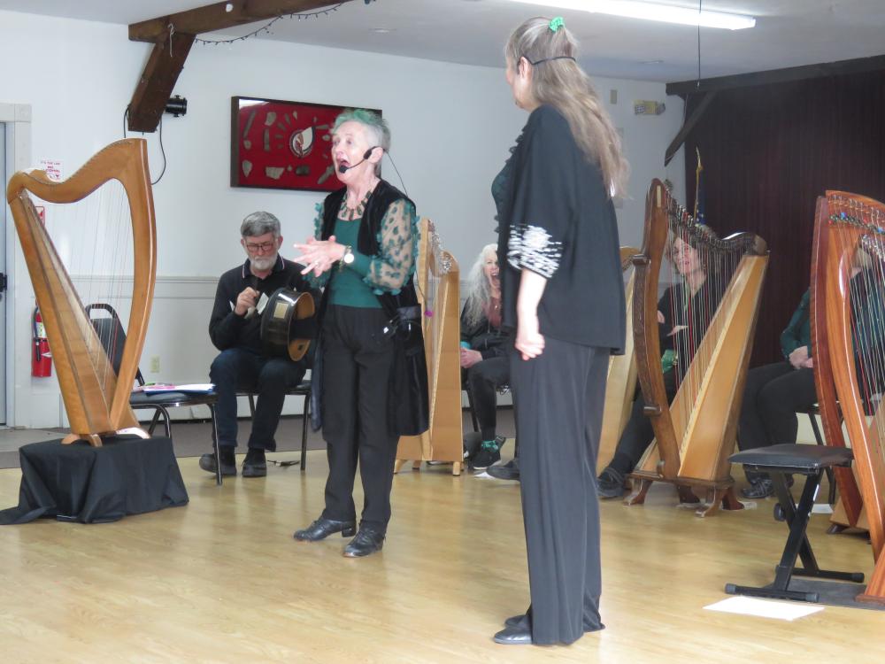 Regina Delaney, left, sings an Irish folk song backed by harps inside Redmen Hall on Sunday, March 29. Photos by Grace Roche