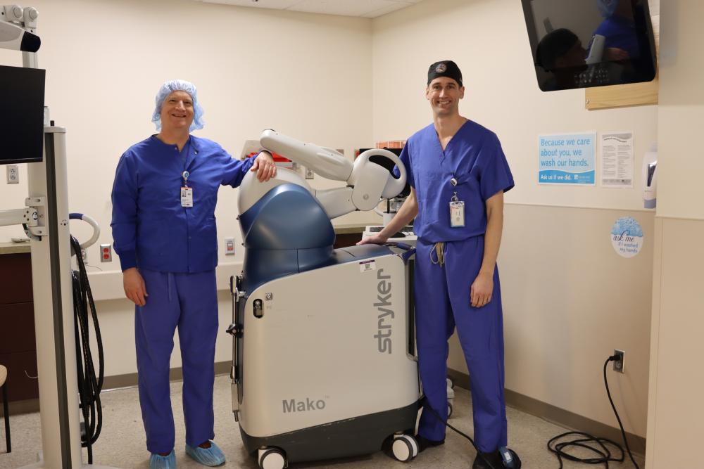 Dr. Christian Dee, left, and Dr. John Carroll show off the new robotic tech at Tobey Hospital. 