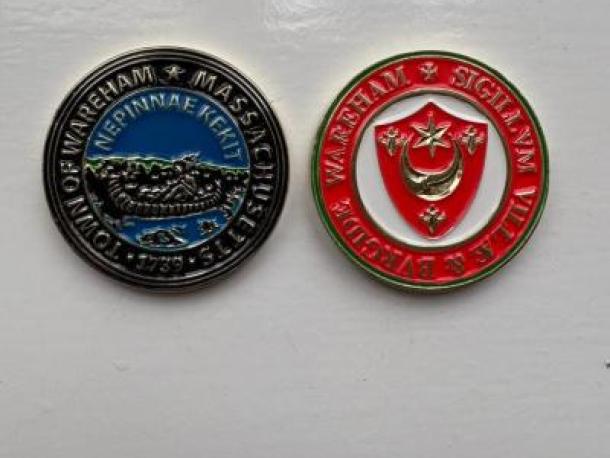 The coins Claire Smith presented with Wareham, MA's town seal and Wareham, U.K.’s town seal. File photo