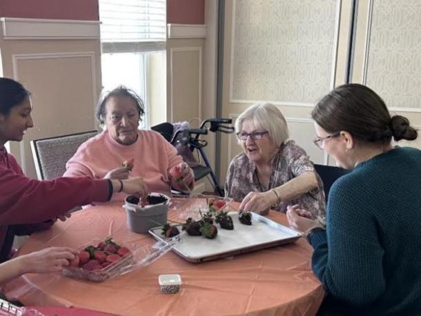Students work to decorate the strawberries with residents. Photos source: Wareham High School