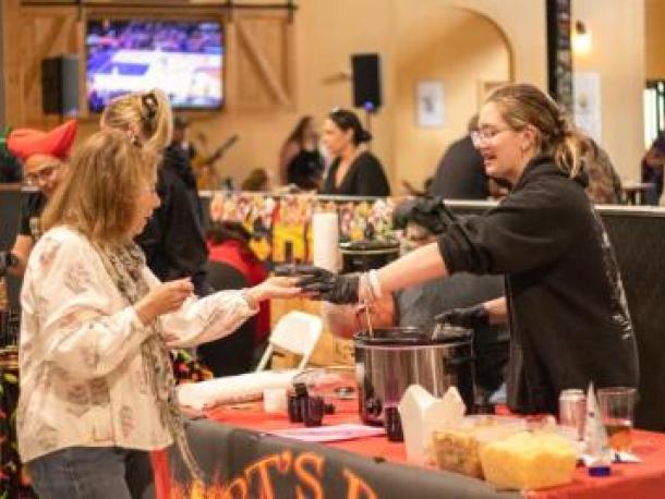 Bella Shephard of Arts BBQ in Middleboro dishes out some chili in 2025. File photo