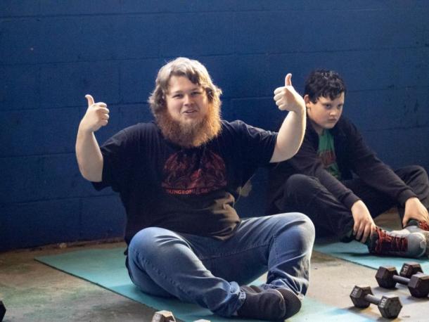 Tyler Maclver stretching before weightlifting. Photos by Brandy Muz