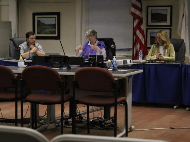 From left, Joey Still, Judith Whiteside and Sarah Corbitt discuss the Purple Heart Community designation. Photo by Brandy Muz