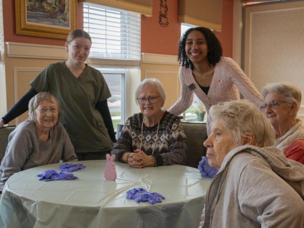 Residents at the table, Rosalie, Patty, Irene and Noreen. Lilly Taylor, Assistant, and Ranie Baptiste, Activities Coordinator. Photos by  Gerrelle Baldwin