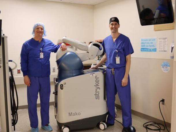 Dr. Christian Dee, left, and Dr. John Carroll show off the new robotic tech at Tobey Hospital. 