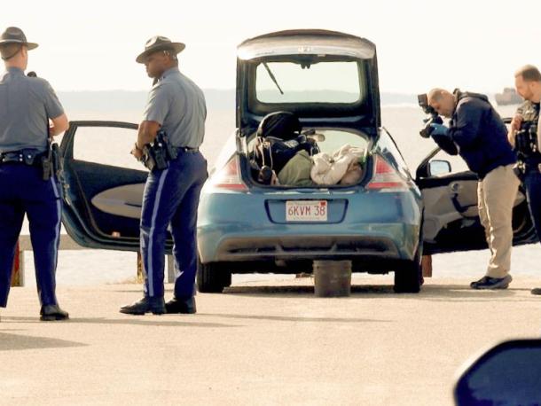 Police searching the vehicle at Swifts beach. Photos by David Curran