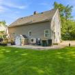 Rear of 17 Beeden Road with a patio, storage shed and wide lawn, Westport, MA