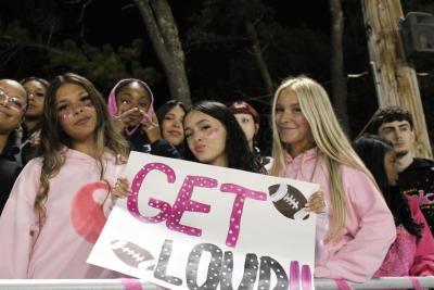 Junior Gianna Hernandez and senior McKenna Duggan with a friend and sign. Photos by Brandy Muz
