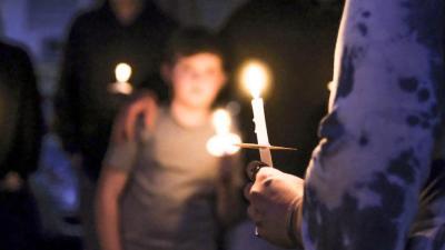 A candle burns during the vigil.