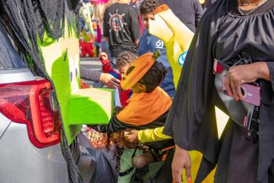 Khyri Gifford, 7, of Wareham reaches up Frankenstein's nose for candy. none
