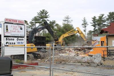 Two excavators are hard at work on the building.