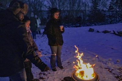 The Roux family gathers for s'mores.