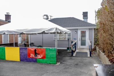 The restaurant is nestled behind Brennan's Smoke Shop.