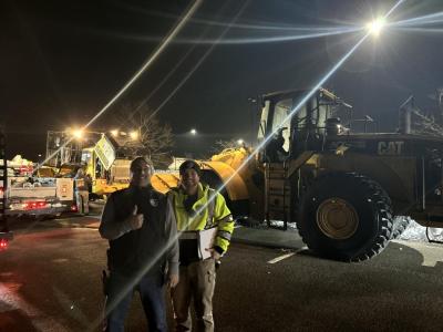 David Menard and Calib LaRue next to front-end loaders.