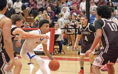 Team captain Aaron Cote dribbles down the court at the Monday final four game. File photo 