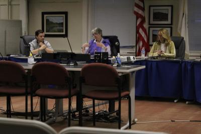 From left, Joey Still, Judith Whiteside and Sarah Corbitt discuss the Purple Heart Community designation. Photo by Brandy Muz