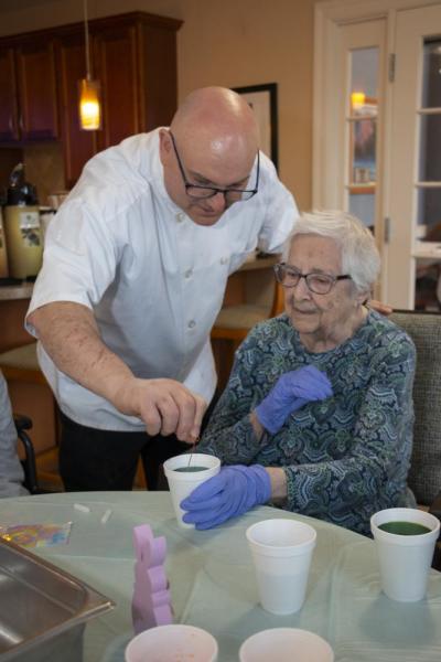 Chef Joe Breda assists resident Claire.