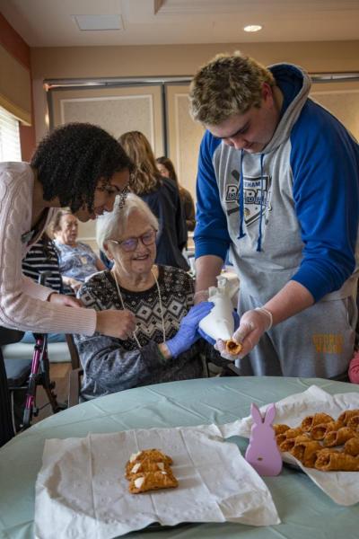 Donovan Leonardi helps resident Patty. 
