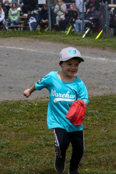 A Webb Plumbing player goes for the ball in the out field. 