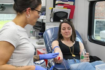 Phlebotomist Ashley Williams, left, prepares to draw Scotlyn LaRue's blood for the drive benefiting Boston Children's Hospital.