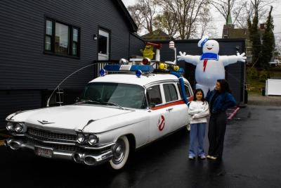 PINKLIDS makes a pit stop. Lead singer Amber Lawson, left, and her little sister with the ghost busters vehicle. 