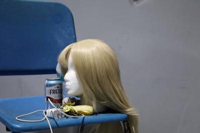 One of the show's many wigs sitting on a mannequin at rehearsal.
