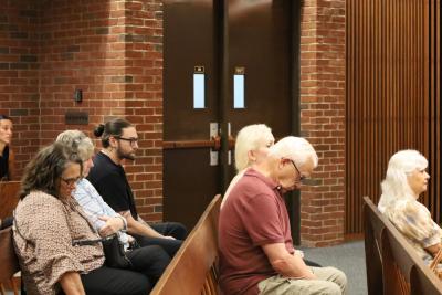 Chadwick's family members and Select Board member Judith Whiteside, center in the leftmost row, watch the proceedings. 