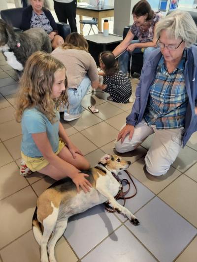 Beth Schweitzer, right, brought her comfort dog, Dickens, to the awards ceremony at the Gleason Family YMCA.