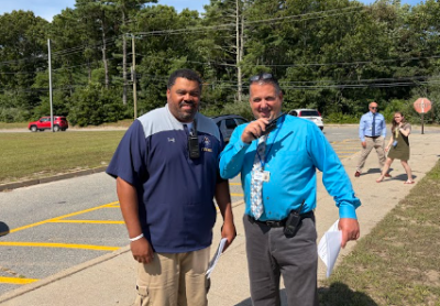 Coach Stephen Faniel and Principal Scott Palladino see off kids after the first day of school. Photo by Christian Uva