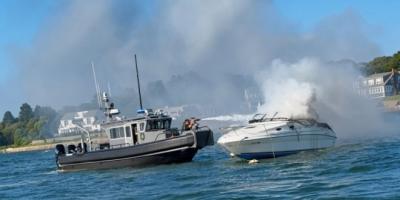 A Wareham Department of Natural Resources vessel douses the burning boat with a water cannon on Saturday, Aug. 8. Photo source: Wareham Department of Natural Resources