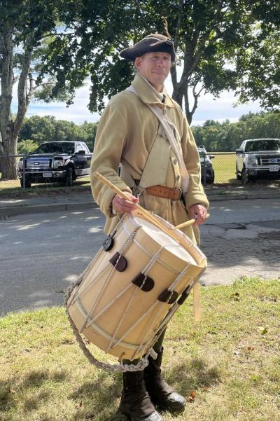 A drummer from the fife and drum corps. During the ceremony, U.S. Rep William Keating said the corps was used as a method of communication, such as signalling when to wake up or emergencies on the field.