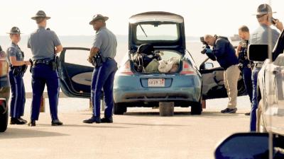 Police searching the vehicle at Swifts beach. Photos by David Curran