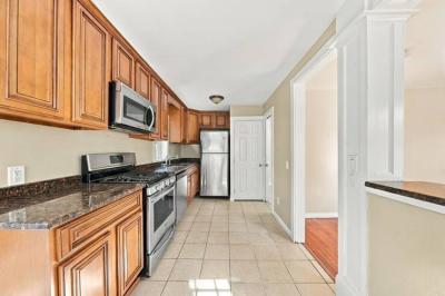 View along the kitchen toward the hardwood-floored living area in the 2 bedroom apartment at 17 Beeden Road, Westport