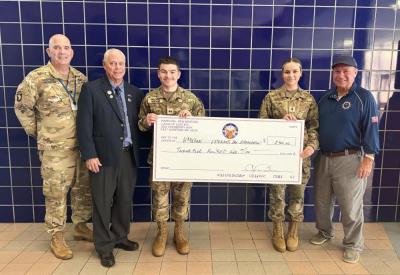 Col. Matt Stanton and JRTOC cadets Aaron Legg and Emily Morais accept a donation toward the town's Veterans Day Parade. Photo source: Nora Bicki