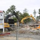 Two excavators are hard at work on the building.