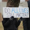 The protest is peaceful with both sides waving signs and chants being called out.