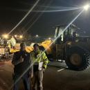 David Menard and Calib LaRue next to front-end loaders.