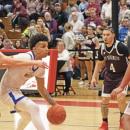 Team captain Aaron Cote dribbles down the court at the Monday final four game. File photo 