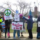 Protestors oppose Trump's presidency and call for peace. 