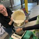A chef from Pit's Pub pours chowder into the crockpot. 