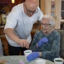 Chef Joe Breda assists resident Claire.