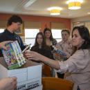 DECA Advisor Lisa Cunha divvies out the supplies.