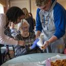Donovan Leonardi helps resident Patty. 