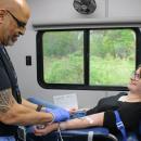 Phlebotomist Angel Martinez, left, begins drawing Arisa Whynot's blood during the Wareham Police Department's blood drive on Saturday, May 9. Photos by Grace Roche