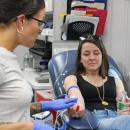 Phlebotomist Ashley Williams, left, prepares to draw Scotlyn LaRue's blood for the drive benefiting Boston Children's Hospital.